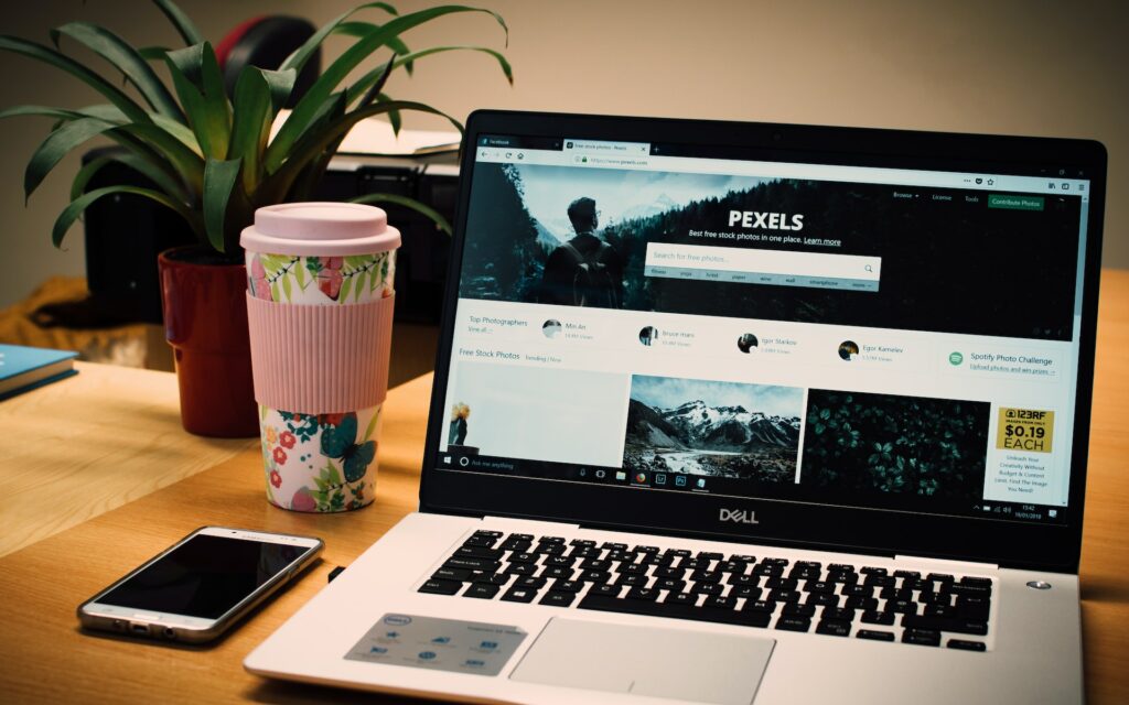Photo of a Gray Dell Laptop Displaying Pexels Webpage