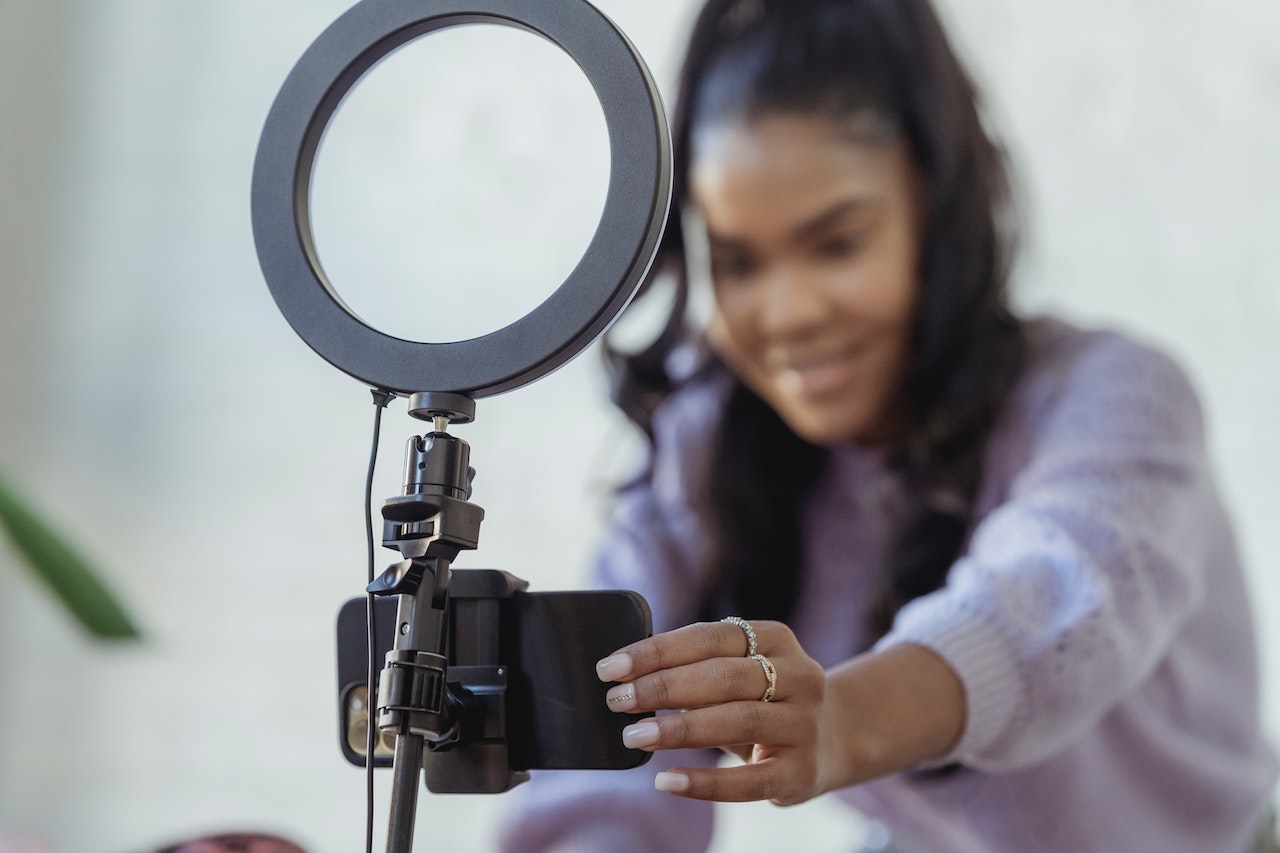 Woman setting up ring light and phone